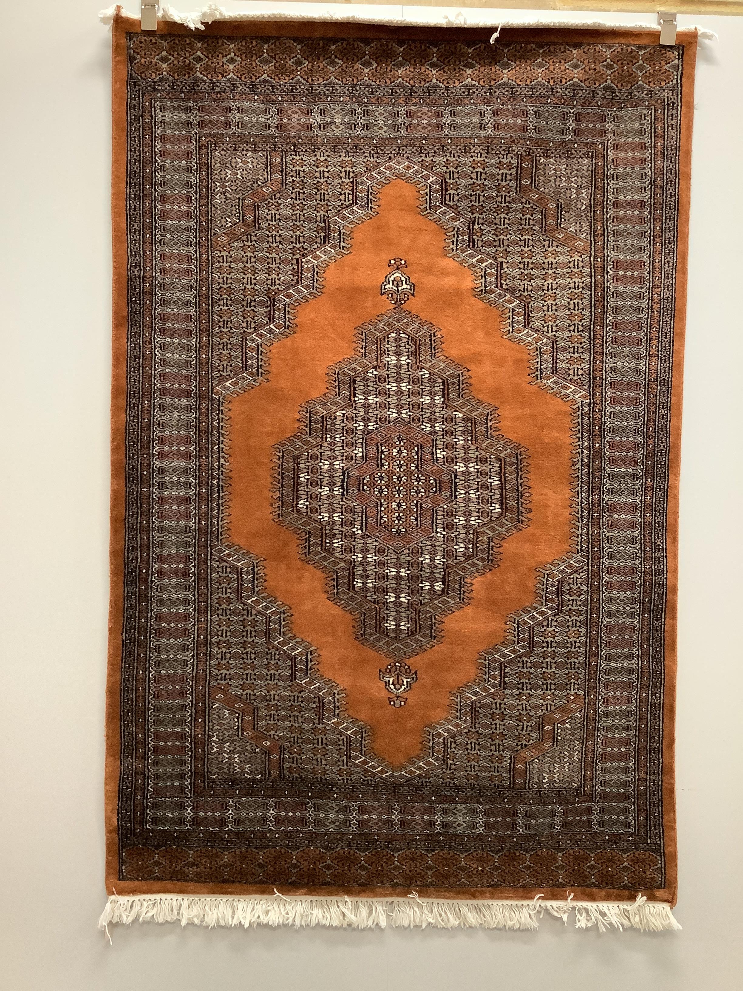 A Bokhara red ground rug and an Afghan rug, larger 184 x 120cm